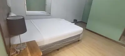 a white bed in a room with a mirror at Casa de Huéspedes Noche de Luna in San Salvador