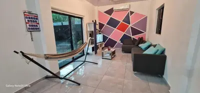 a living room with a couch and a hammock at Evolution Home in Astoria