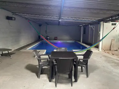 a swimming pool with a table and chairs around it at Evolution Home in Astoria