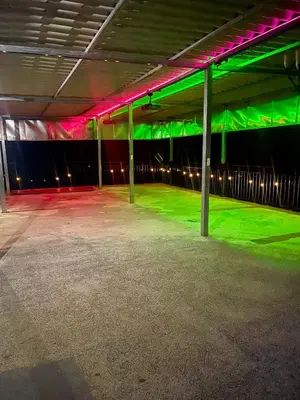 an empty parking garage with green and pink lighting at Evolution Home in Astoria
