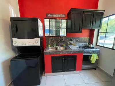 a small kitchen with a television and a stove at Evolution Home in Astoria