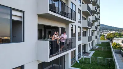 three people standing on a balcony of a building at View of The Capital, Escalon SV in San Salvador