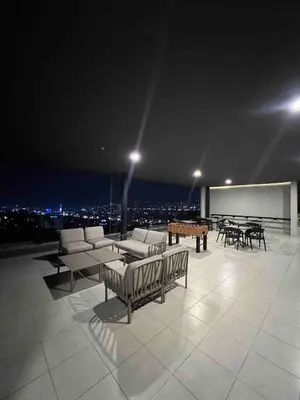 a room with chairs and a table on a roof at View of The Capital, Escalon SV in San Salvador