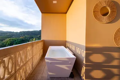a bath tub sitting on top of a balcony at Spacious Apartment with Balcony in El Zonte