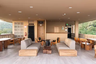 a restaurant with tables and couches and tables and chairs at Spacious Apartment with Balcony in El Zonte