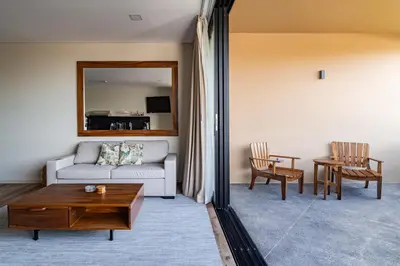 a living room with a couch and a table at Spacious Apartment with Balcony in El Zonte