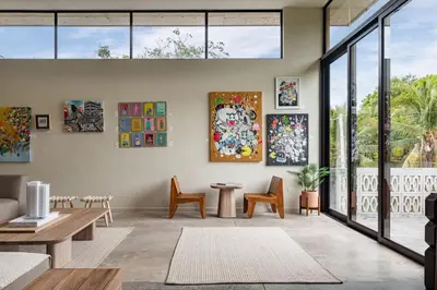 a living room with paintings on the wall at Spacious Apartment with Balcony in El Zonte