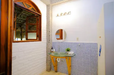 a bathroom with a small table in the corner at Casa K59 - Walk to Beach in Taquillo