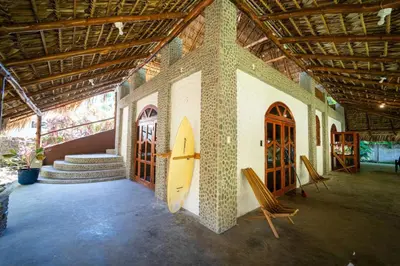 a room with a surfboard on the side of a building at Casa K59 - Walk to Beach in Taquillo