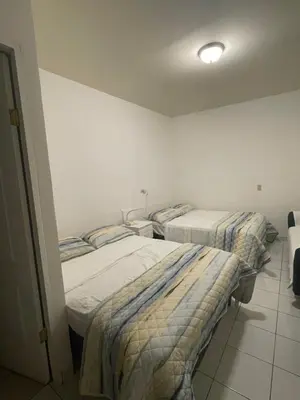 three beds in a room with white walls at Two Beds San Francisco Chinameca in San Francisco Chinameca