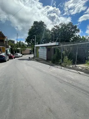 an empty street with a fence and a building at Two Beds San Francisco Chinameca in San Francisco Chinameca