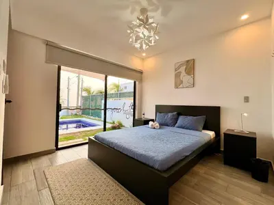 a bedroom with a large bed and a large window at Luxury Apartment- View- Pool- La Libertad Surfcity in La Libertad