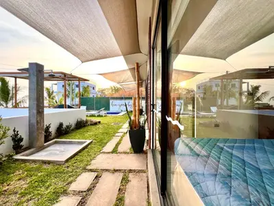 an open glass door of a house with a yard at Luxury Apartment- View- Pool- La Libertad Surfcity in La Libertad