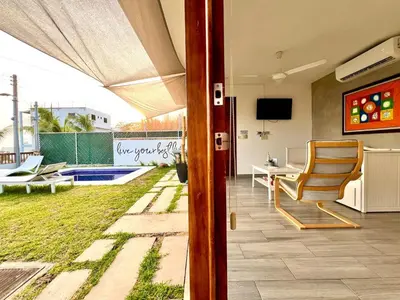 a view of a patio with a chair and a table at Luxury Apartment- View- Pool- La Libertad Surfcity in La Libertad