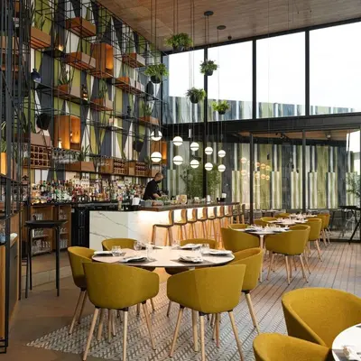 a restaurant with tables and chairs and a bar at El Tunco Beachfront Surf City Spot in Tamanique
