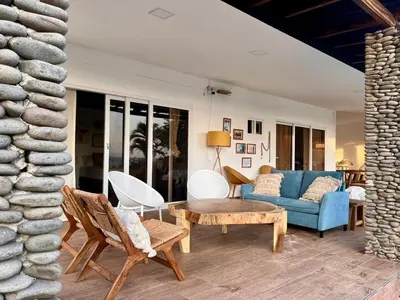 a living room with a blue couch and a table at El Tunco Beachfront Surf City Spot in Tamanique