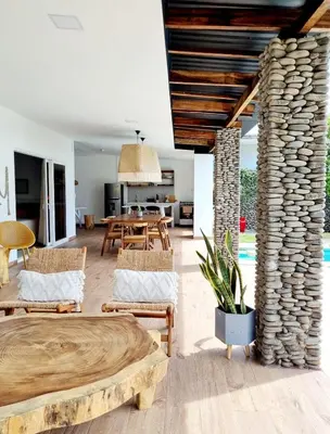 an open living room with chairs and a table at El Tunco Beachfront Surf City Spot in Tamanique