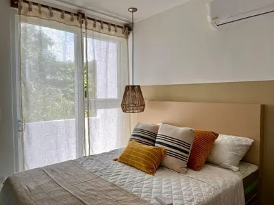 a bedroom with a bed with pillows and a window at via costera 1 in La Libertad