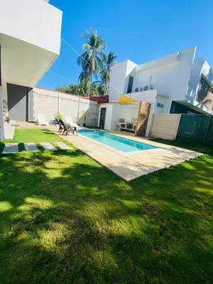 a house with a swimming pool in the yard at via costera 1 in La Libertad