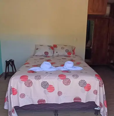 a bed with two hats and towels on it at California Beach, Teotepeque, La Libertad in Las Victorias