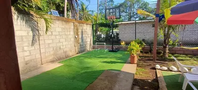 a backyard with a artificial turf basketball court at California Beach, Teotepeque, La Libertad in Las Victorias