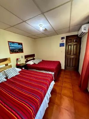 a hotel room with two beds in a room at Hotel Casa Miramar in Tamanique