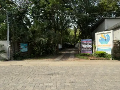 a street with trees and signs on the side of a building at Hotel Casa Miramar in Tamanique