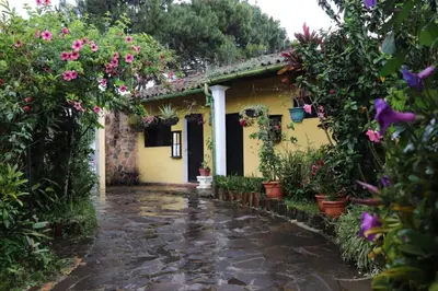 a garden entrance to a house with flowers at Hotel Villa Santo Domingo in Concepción de Ataco