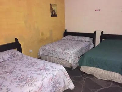 a room with two beds in a room at Hotel Villa Santo Domingo in Concepción de Ataco