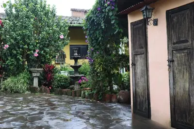 an open door to a courtyard with flowers at Hotel Villa Santo Domingo in Concepción de Ataco