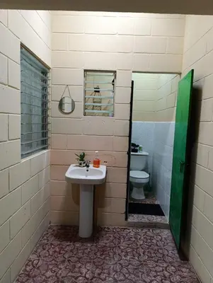 a bathroom with a sink and a toilet at Room Buganvilia in Nahuizalco