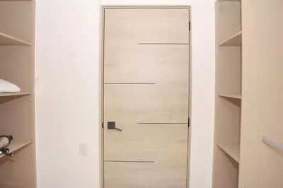 a wooden door in a room with shelves at The Balcony of the City in San Salvador