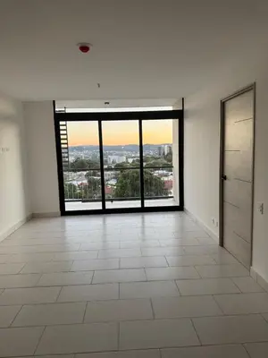 an empty room with a large window with a view at The Balcony of the City in San Salvador