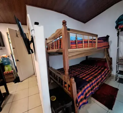 a bedroom with bunk beds in a room at Zonte Rooftop Studio Apartment w Terrace-AC-Wif-BBQ in El Zonte