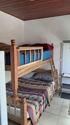 a bedroom with two bunk beds in a room at Zonte Rooftop Studio Apartment w Terrace-AC-Wif-BBQ in El Zonte