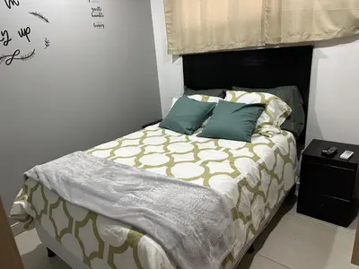 a bed with two pillows on it in a bedroom at Luxury Apartment in San Salvador in San Salvador