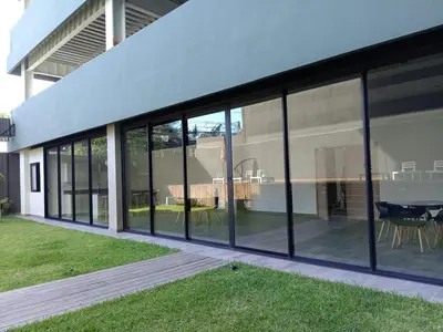 an external view of a building with large glass windows at Luxury Apartment in San Salvador in San Salvador