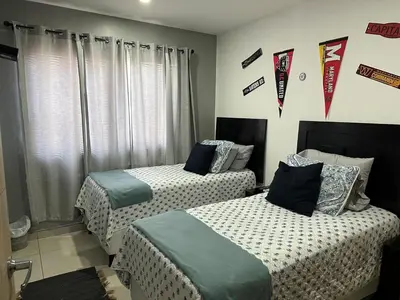 two beds in a room with flags on the wall at Luxury Apartment in San Salvador in San Salvador