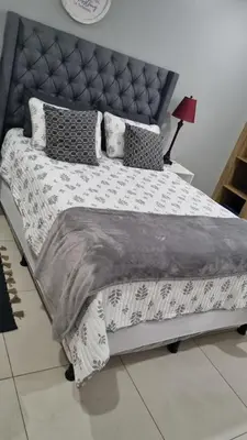 a bedroom with a bed with a black and white comforter at Luxury Apartment in San Salvador in San Salvador