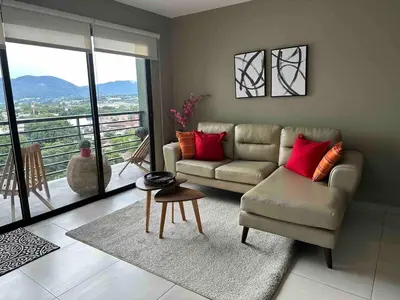 a living room with a couch and a table at Luxury Apartment in San Salvador in San Salvador