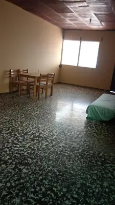 a room with a table and chairs and a bed at Casa San Fernando, Ahuachapan in Ahuachapán