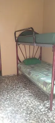 a bunk bed in a room with a green mattress at Casa San Fernando, Ahuachapan in Ahuachapán