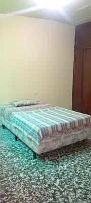 a bedroom with a bed in a room with at Casa San Fernando, Ahuachapan in Ahuachapán