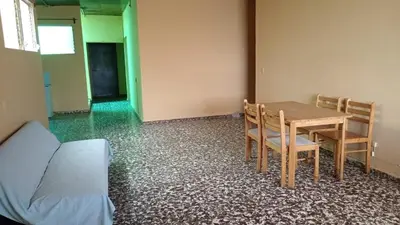 a room with a table and chairs and a bed at Casa San Fernando, Ahuachapan in Ahuachapán
