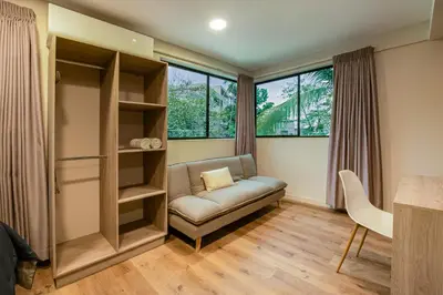 a living room with a couch and a window at Lora Loca Inn in El Zonte