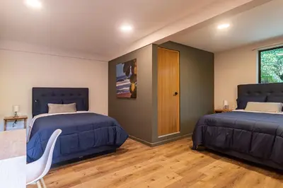 a bedroom with two beds and a window at Lora Loca Inn in El Zonte
