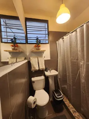 a bathroom with a toilet and a sink at Mochila Urban1 in San Salvador