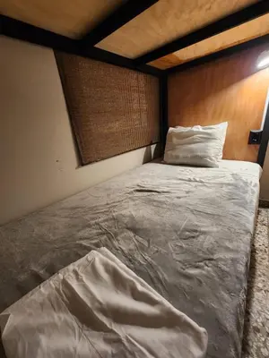 a large bed in a room with a wooden wall at Mochila Urban1 in San Salvador