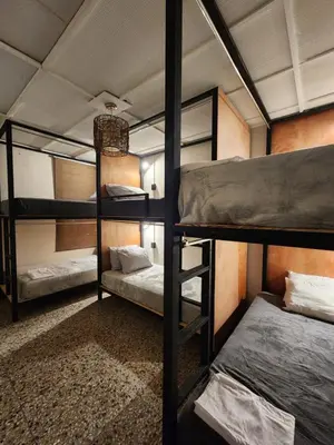 a bedroom with three bunk beds in a room at La Mochila Urbana2 in San Salvador