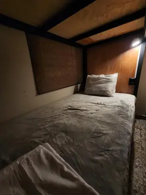 a bedroom with a large bed with a wooden headboard at La Mochila Urbana2 in San Salvador